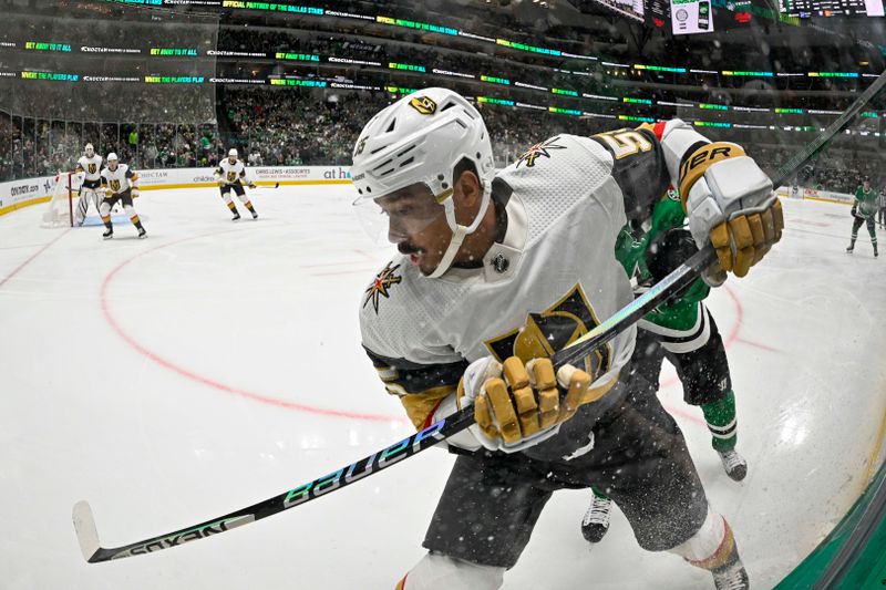 Dec 9, 2023; Dallas, Texas, USA; Vegas Golden Knights right wing Keegan Kolesar (55) attempts to control the puck along the boards during the second period against the Dallas Stars at the American Airlines Center. Mandatory Credit: Jerome Miron-USA TODAY Sports