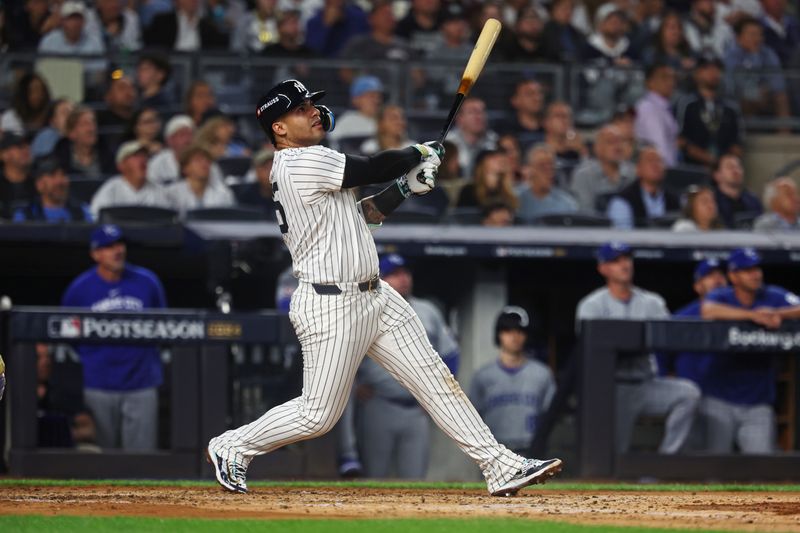 Oct 5, 2024; Bronx, New York, USA; New York Yankees second base Gleyber Torres (25) hits a two run home run during the third inning against the Kansas City Royals during game one of the ALDS for the 2024 MLB Playoffs at Yankee Stadium. Mandatory Credit: Vincent Carchietta-Imagn Images