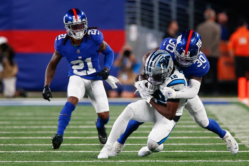 New York Giants' Darnay Holmes (30), right, tackles Carolina Panthers' Shi Smith during the second half of an NFL preseason football game, Friday, Aug. 18, 2023, in East Rutherford, N.J. (AP Photo/John Munson)