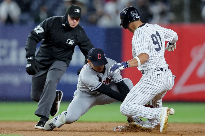 May 3, 2023; Bronx, New York, USA; New York Yankees pinch runner Oswald Peraza (91) is safe a second as the ball gets by Cleveland Guardians second baseman Andres Gimenez (0) during the ninth inning at Yankee Stadium. Mandatory Credit: Brad Penner-USA TODAY Sports