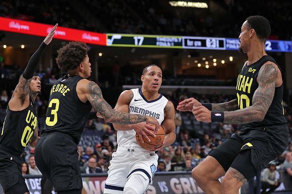 MEMPHIS, TENNESSEE - NOVEMBER 29: Desmond Bane #22 of the Memphis Grizzlies goes to the basket against Keyonte George #3 of the Utah Jazz during the first half at FedExForum on November 29, 2023 in Memphis, Tennessee. NOTE TO USER: User expressly acknowledges and agrees that, by downloading and or using this photograph, User is consenting to the terms and conditions of the Getty Images License Agreement.  (Photo by Justin Ford/Getty Images)