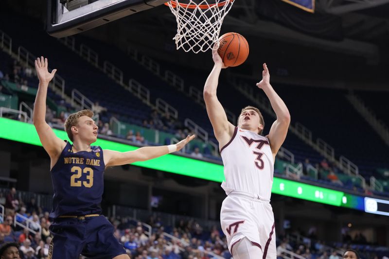 Mar 7, 2023; Greensboro, NC, USA; Virginia Tech Hokies guard Sean Pedulla (3) shoots as Notre Dame Fighting Irish guard Dane Goodwin (23) defends in the second half at Greensboro Coliseum. Mandatory Credit: Bob Donnan-USA TODAY Sports