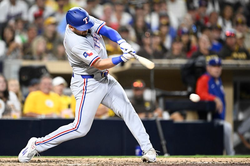 Jul 6, 2025; San Diego, California, USA; Texas Rangers first baseman Jake Burger (21) hits a single during the seventh inning against the San Diego Padres at Petco Park. Mandatory Credit: Denis Poroy-Imagn Images