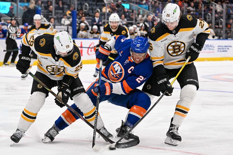Nov 27, 2024; Elmont, New York, USA;  Boston Bruins defenseman Parker Wotherspoon (29) and Boston Bruins defenseman Brandon Carlo (25) defend against New York Islanders left wing Anders Lee (27) during the second period at UBS Arena. Mandatory Credit: Dennis Schneidler-Imagn Images