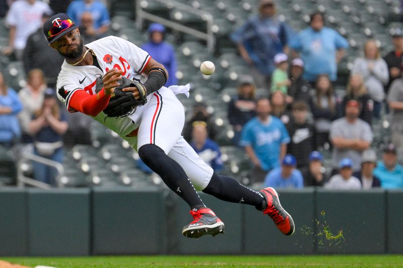 May 27, 2024; Minneapolis, Minnesota, USA; Minnesota Twins infielder Willi Castro (50) is charged with a throwing error on this play against the Kansas City Royals during the ninth inning at Target Field. Mandatory Credit: Nick Wosika-USA TODAY Sports