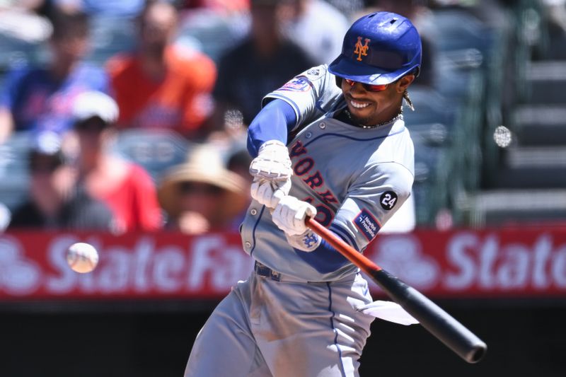 Aug 4, 2024; Anaheim, California, USA; New York Mets shortstop Francisco Lindor (12) doubles against the Los Angeles Angels during the fifth inning at Angel Stadium. Mandatory Credit: Jonathan Hui-USA TODAY Sports