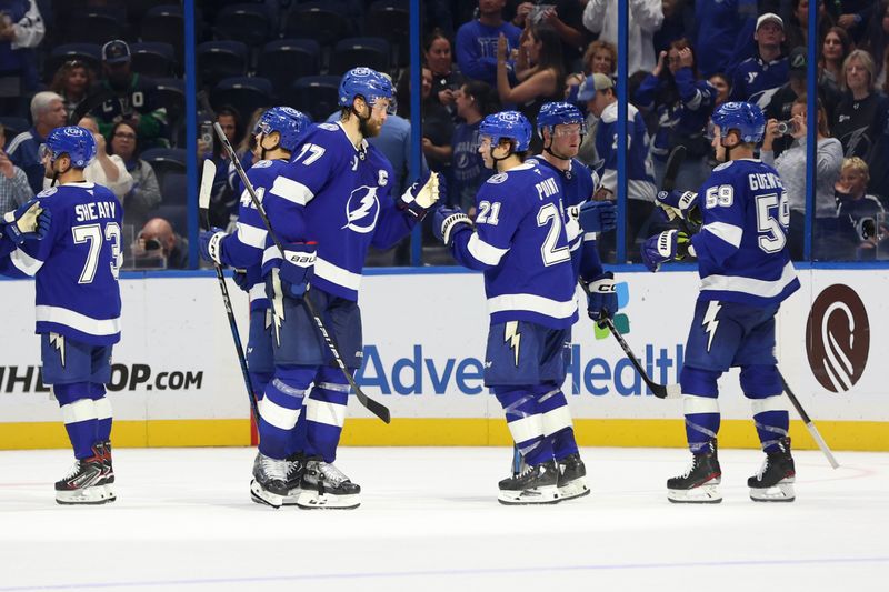 Oct 15, 2024; Tampa, Florida, USA; Tampa Bay Lightning defenseman Victor Hedman (77) and center Brayden Point (21) celebrate after they beat the Vancouver Canucks during the third period at Amalie Arena. Mandatory Credit: Kim Klement Neitzel-Imagn Images