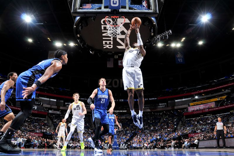 ORLANDO, FL - FEBRUARY 29: Kris Dunn #11 of the Utah Jazz drives to the basket during the game against the Orlando Magic on February 29, 2024 at Amway Center in Orlando, Florida. NOTE TO USER: User expressly acknowledges and agrees that, by downloading and or using this photograph, User is consenting to the terms and conditions of the Getty Images License Agreement. Mandatory Copyright Notice: Copyright 2024 NBAE (Photo by Fernando Medina/NBAE via Getty Images)