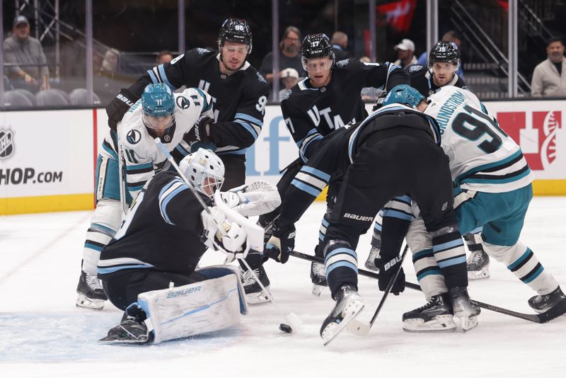 Oct 28, 2024; Salt Lake City, Utah, USA; Utah Hockey Club center Liam O'Brien (38) uses his stick to protect the puck during the first period against the San Jose Sharks at Delta Center. Mandatory Credit: Chris Nicoll-Imagn Images