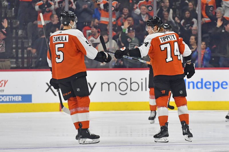 Jan 18, 2024; Philadelphia, Pennsylvania, USA; Philadelphia Flyers right wing Owen Tippett (74) celebrates his goal with defenseman Egor Zamula (5) against the Dallas Stars during the second period at Wells Fargo Center. Mandatory Credit: Eric Hartline-USA TODAY Sports