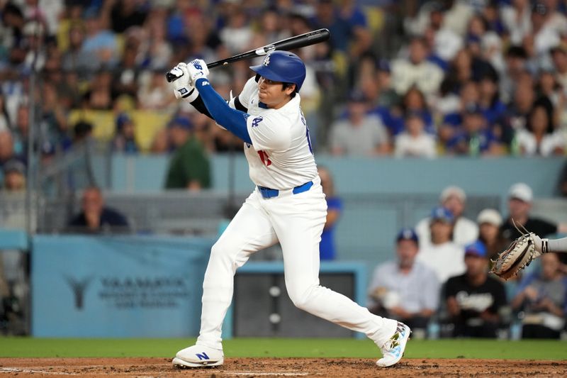 Aug 20, 2024; Los Angeles, California, USA; Los Angeles Dodgers designated hitter Shohei Ohtani (17) hits a triple in the third inning against the Seattle Mariners at Dodger Stadium. Mandatory Credit: Kirby Lee-USA TODAY Sports