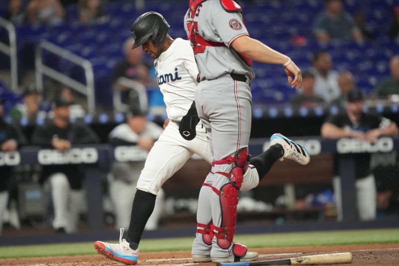 Sep 11, 2025; Miami, Florida, USA;  Miami Marlins second baseman Xavier Edwards (9) scores a run in the first inning against the Washington Nationals at loanDepot Park. Mandatory Credit: Jim Rassol-Imagn Images