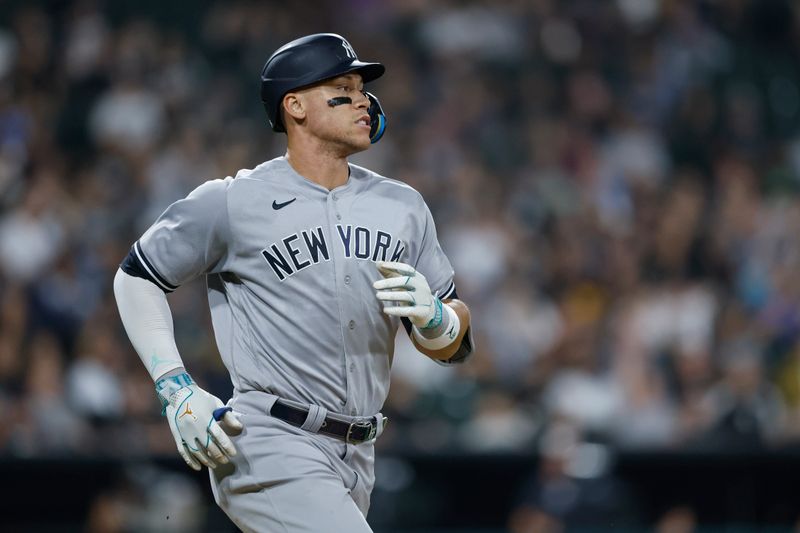 Aug 9, 2023; Chicago, Illinois, USA; New York Yankees right fielder Aaron Judge (99) runs to first base after hitting a single against the Chicago White Sox during the eight inning at Guaranteed Rate Field. Mandatory Credit: Kamil Krzaczynski-USA TODAY Sports