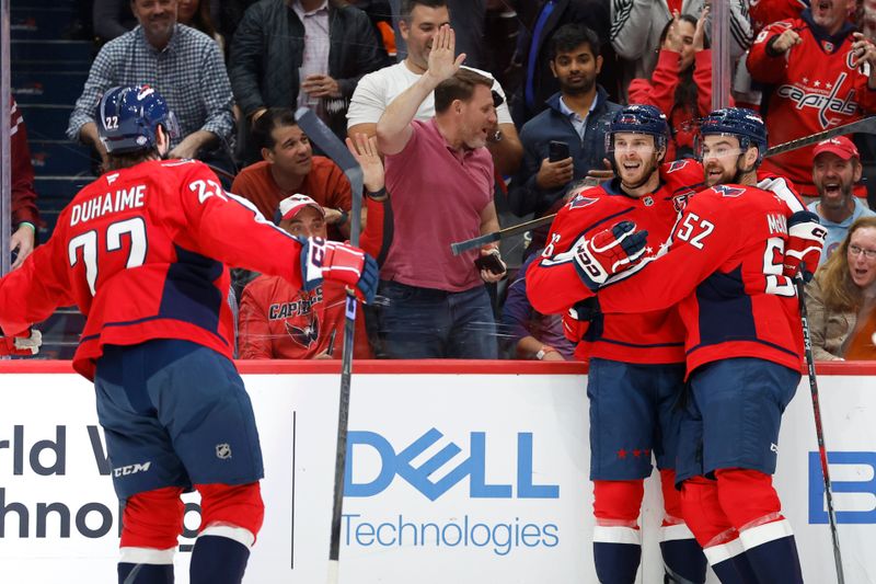 Oct 23, 2024; Washington, District of Columbia, USA; Washington Capitals right wing Taylor Raddysh (16) celebrates with teammates after scoring a goal against the Philadelphia Flyers in the first period at Capital One Arena. Mandatory Credit: Geoff Burke-Imagn Images