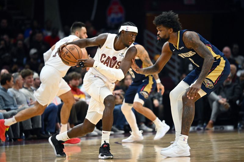 CLEVELAND, OHIO - DECEMBER 21: Caris LeVert #3 of the Cleveland Cavaliers drives to the basket around Naji Marshall #8 of the New Orleans Pelicans during the second half at Rocket Mortgage Fieldhouse on December 21, 2023 in Cleveland, Ohio. The Pelicans defeated the Cavaliers 123-104. NOTE TO USER: User expressly acknowledges and agrees that, by downloading and or using this photograph, User is consenting to the terms and conditions of the Getty Images License Agreement. (Photo by Jason Miller/Getty Images)