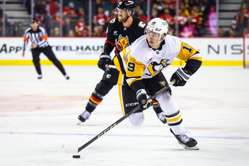 Oct 22, 2024; Calgary, Alberta, CAN; Pittsburgh Penguins center Cody Glass (19) controls the puck against the Calgary Flames during the first period at Scotiabank Saddledome. Mandatory Credit: Sergei Belski-Imagn Images