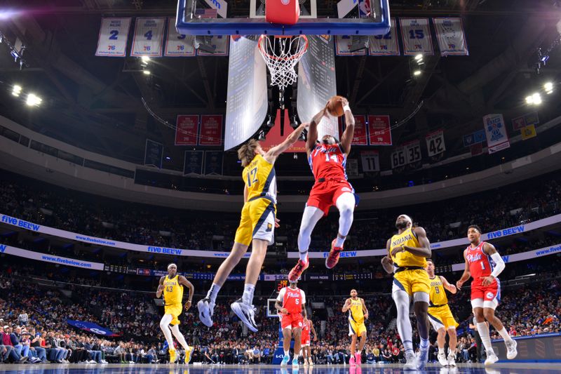 PHILADELPHIA, PA - DECEMBER 13: Ricky Council IV #14 of the Philadelphia 76ers drives to the basket during the game against the Indiana Pacers on December 13, 2024 at the Wells Fargo Center in Philadelphia, Pennsylvania NOTE TO USER: User expressly acknowledges and agrees that, by downloading and/or using this Photograph, user is consenting to the terms and conditions of the Getty Images License Agreement. Mandatory Copyright Notice: Copyright 2024 NBAE (Photo by Jesse D. Garrabrant/NBAE via Getty Images)