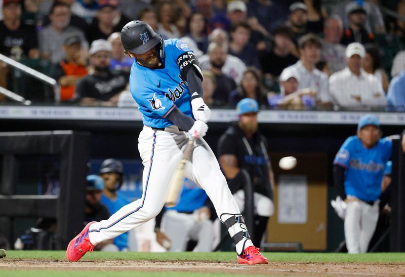 Mar 6, 2026; Jupiter, Florida, USA;  Miami Marlins third baseman Connor Norby (1) hits a solo home run against the New York Mets during the first inning at Roger Dean Chevrolet Stadium. Mandatory Credit: Rhona Wise-Imagn Images