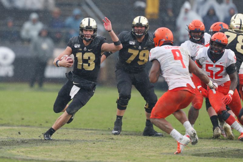 Oct 26, 2019; West Lafayette, IN, USA; Purdue Boilermakers quarterback Jack Plummer (13) runs with the ball against the Illinois Fighting Illini during the third quarter at Ross-Ade Stadium. Mandatory Credit: Brian Spurlock-USA TODAY Sports