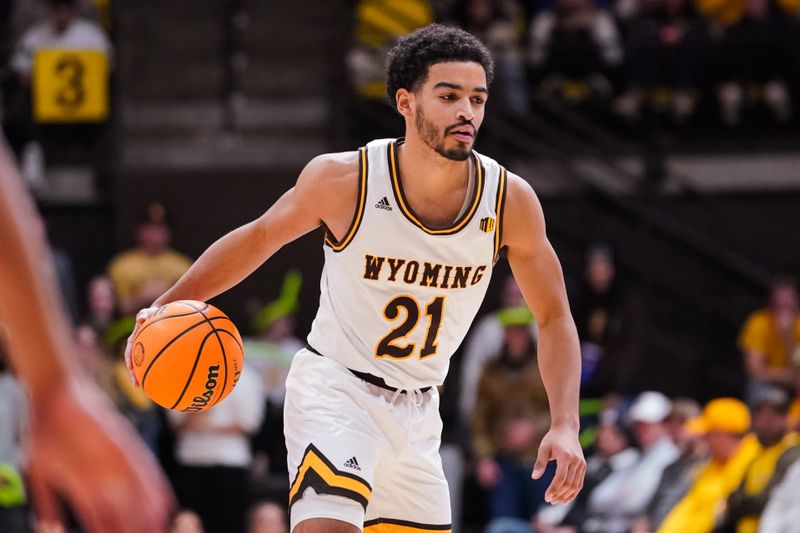 Jan 31, 2023; Laramie, Wyoming, USA; Wyoming Cowboys guard Noah Reynolds (21) dribbles the ball against the Fresno State Bulldogs during the second half against at Arena-Auditorium. Mandatory Credit: Troy Babbitt-USA TODAY Sports