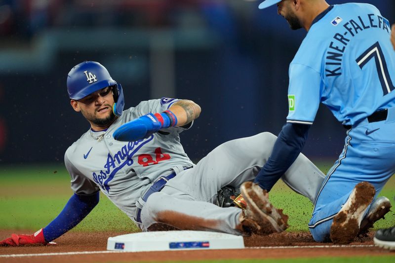 Apr 28, 2024; Toronto, Ontario, CAN; Los Angeles Dodgers right fielder Andy Pages (84) gets a tagged out by Toronto Blue Jays third baseman Isiah Kiner-Falefa (7) trying to steal third base during the second inning at Rogers Centre. Mandatory Credit: John E. Sokolowski-USA TODAY Sports