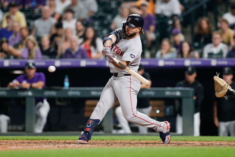 Jul 22, 2024; Denver, Colorado, USA; Boston Red Sox outfielder Wilyer Abreu (52) hits an RBI single in the twelfth inning against the Colorado Rockies at Coors Field. Mandatory Credit: Isaiah J. Downing-USA TODAY Sports