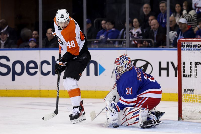 Mar 26, 2024; New York, New York, USA; New York Rangers goaltender Igor Shesterkin (31) makes a save in front of Philadelphia Flyers center Morgan Frost (48) during the second period at Madison Square Garden. Mandatory Credit: Brad Penner-USA TODAY Sports