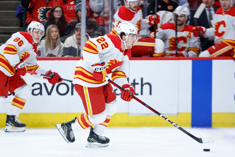 Jan 13, 2025; Chicago, Illinois, USA; Calgary Flames left wing Jakob Pelletier (22) controls the puck against the Chicago Blackhawks during the first period at United Center. Mandatory Credit: Kamil Krzaczynski-Imagn Images