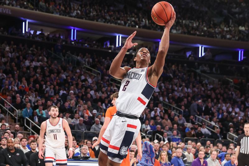 Dec 9, 2025; New York, New York, USA;  UConn Huskies guard Silas Demary Jr. (2) drives to the basket in the first half against the Florida Gators at Madison Square Garden. Mandatory Credit: Wendell Cruz-Imagn Images
