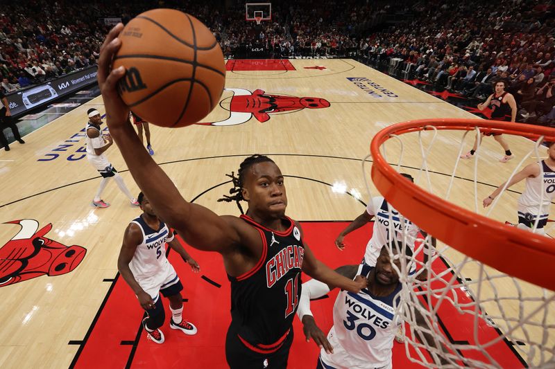 CHICAGO, ILLINOIS - NOVEMBER 07: Ayo Dosunmu #11 of the Chicago Bulls dunks against the Minnesota Timberwolves during the first half at the United Center on November 07, 2024 in Chicago, Illinois. NOTE TO USER: User expressly acknowledges and agrees that, by downloading and or using this photograph, User is consenting to the terms and conditions of the Getty Images License Agreement.  (Photo by Michael Reaves/Getty Images)