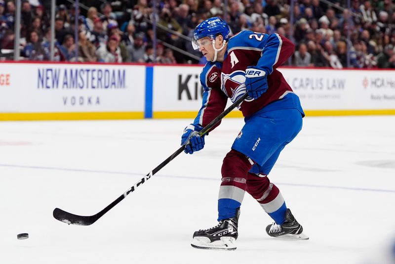 Jan 14, 2025; Denver, Colorado, USA; Colorado Avalanche center Nathan MacKinnon (29) shoots the puck in the second period against the New York Rangers at Ball Arena. Mandatory Credit: Ron Chenoy-Imagn Images