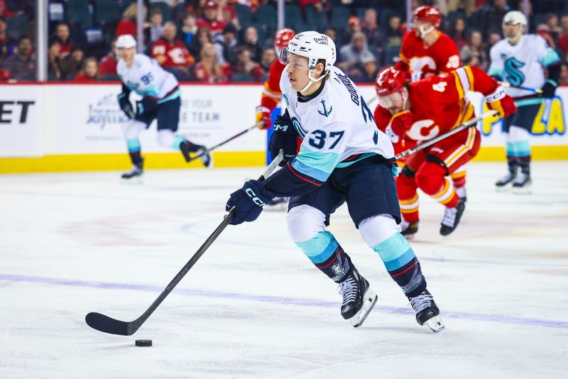 Mar 4, 2024; Calgary, Alberta, CAN; Seattle Kraken center Yanni Gourde (37) controls the puck against the Calgary Flames during the first period at Scotiabank Saddledome. Mandatory Credit: Sergei Belski-USA TODAY Sports