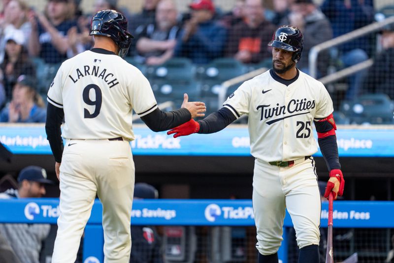 Apr 23, 2024; Minneapolis, Minnesota, USA; Minnesota Twins outfielder Trevor Larnach (9) is congratulated by outfielder Byron Buxton (25) after scoring on a hit by outfielder Max Kepler (not pictured) in the first inning against the Chicago White Sox at Target Field. Mandatory Credit: Matt Blewett-USA TODAY Sports