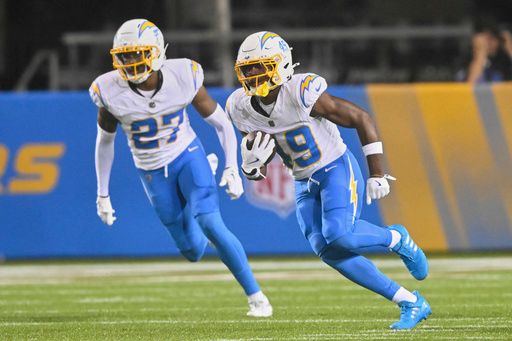 Los Angeles Chargers cornerback Myles Purchase (49) runs with the ball after an interception in the second half of the Pro Football Hall of Fame NFL preseason game against the Detroit Lions, Thursday, July 31, 2025, in Canton, Ohio. (AP Photo/David Richard)