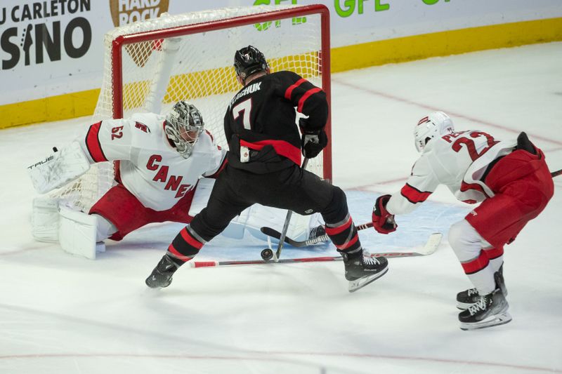 Dec 12, 2023; Ottawa, Ontario, CAN; Carolina Hurricanes goalie Pyotr Kochetkov (52) makes a save on a shot from Ottawa Senators left wing Brady Tkachuk (7) in the third period at the Canadian Tire Centre. Mandatory Credit: Marc DesRosiers-USA TODAY Sports.