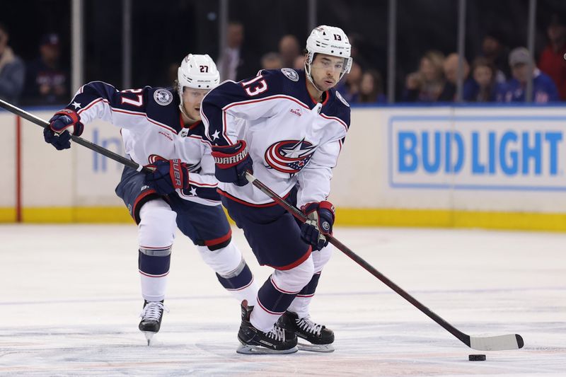 Feb 28, 2024; New York, New York, USA; Columbus Blue Jackets left wing Johnny Gaudreau (13) brings the puck up ice against the New York Rangers with defenseman Adam Boqvist (27) during the first period at Madison Square Garden. Mandatory Credit: Brad Penner-USA TODAY Sports