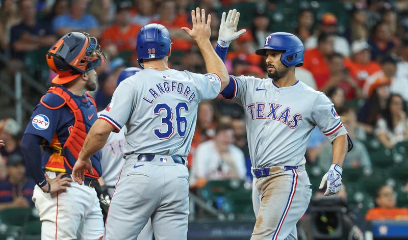 Apr 14, 2024; Houston, Texas, USA; Texas Rangers second baseman Marcus Semien (2) celebrates with designated hitter Wyatt Langford (36) after hitting a home run during the ninth inning against the Houston Astros at Minute Maid Park. Mandatory Credit: Troy Taormina-USA TODAY Sports