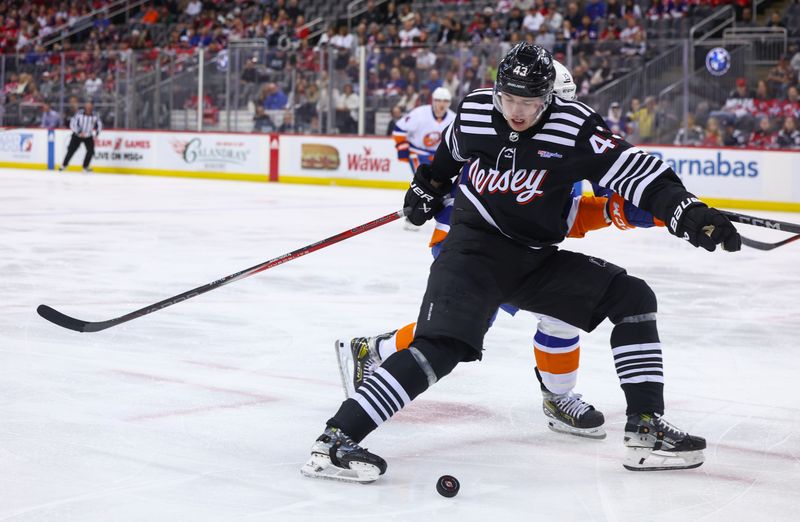 Apr 15, 2024; Newark, New Jersey, USA; New Jersey Devils defenseman Luke Hughes (43) and New York Islanders center Mathew Barzal (13) battle for the puck during the first period at Prudential Center. Mandatory Credit: Ed Mulholland-USA TODAY Sports