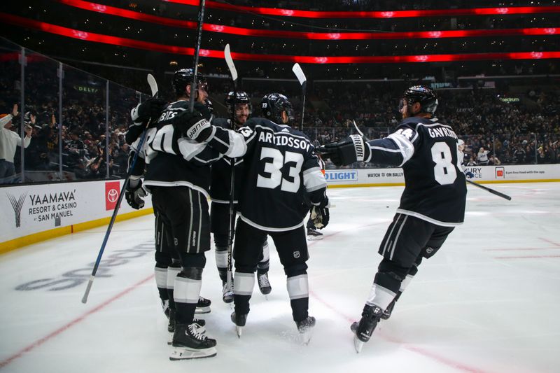 Mar 23, 2024; Los Angeles, California, USA; Members of the Los Angeles Kings celebrate after Los Angeles Kings left wing Trevor Moore (12) scores a goal during the second period of an NHL hockey game against the Tampa Bay Lighting at Crypto.com Arena. Mandatory Credit: Yannick Peterhans-USA TODAY Sports