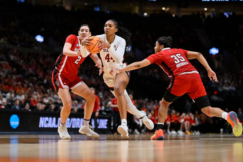 Mar 29, 2024; Portland, OR, USA; Stanford Cardinal forward Kiki Iriafen (44) drives to the basket during the second half against NC State Wolfpack guard Zoe Brooks (35) and forward Mimi Collins (2) in the semifinals of the Portland Regional of the 2024 NCAA Tournament at the Moda Center at the Moda Center. Mandatory Credit: Troy Wayrynen-USA TODAY Sports