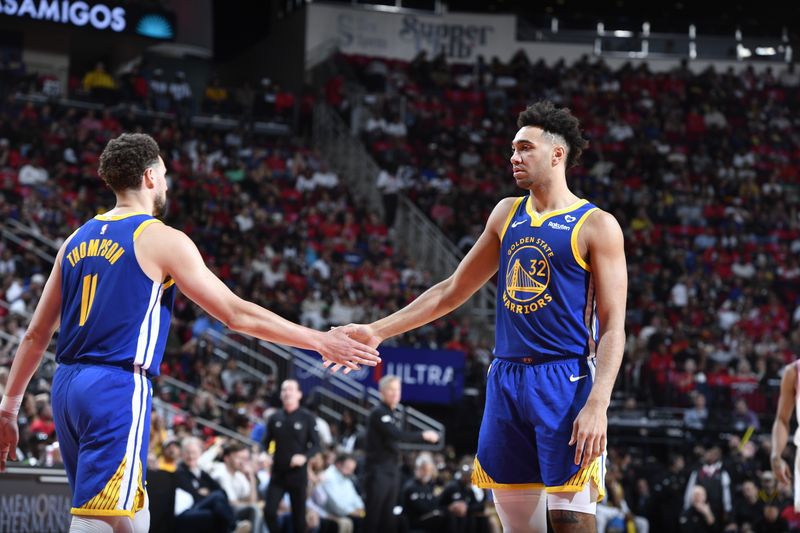 HOUSTON, TX - APRIL 4: Trayce Jackson-Davis #32 high fives Klay Thompson #11 of the Golden State Warriors during the game against the Houston Rockets on April 4, 2024 at the Toyota Center in Houston, Texas. NOTE TO USER: User expressly acknowledges and agrees that, by downloading and or using this photograph, User is consenting to the terms and conditions of the Getty Images License Agreement. Mandatory Copyright Notice: Copyright 2024 NBAE (Photo by Logan Riely/NBAE via Getty Images)