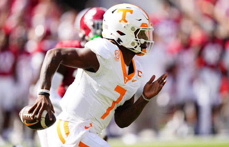 Oct 21, 2023; Tuscaloosa, Alabama, USA; Tennessee Volunteers quarterback Joe Milton III (7) scrambles up the field against the Alabama Crimson Tide during the first half at Bryant-Denny Stadium. Mandatory Credit: John David Mercer-USA TODAY Sports