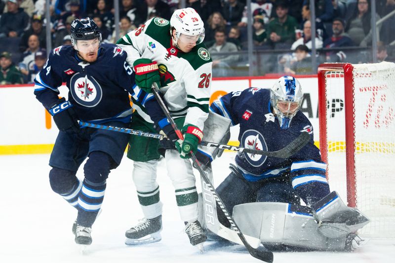 Feb 20, 2024; Winnipeg, Manitoba, CAN; Winnipeg Jets goalie Laurent Boissoit (39) makes a save as Minnesota Wild forward Connor Dewar (26) and Winnipeg Jets defenseman Dylan Samberg (54) look for a rebound during first period at Canada Life Centre. Mandatory Credit: Terrence Lee-USA TODAY Sports