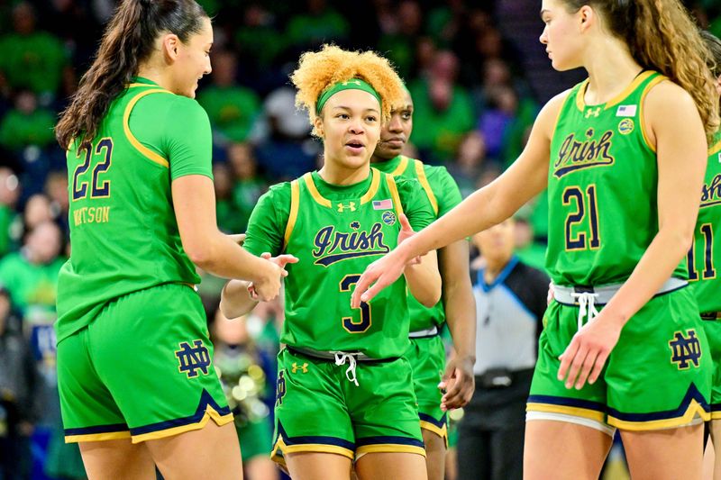 Feb 29, 2024; South Bend, Indiana, USA; Notre Dame Fighting Irish forward Kylee Watson (22) guard Hannah Hidalgo (3) and forward Maddy Westbeld (21) pause in the second half against the Virginia Tech Hokies at the Purcell Pavilion. Mandatory Credit: Matt Cashore-USA TODAY Sports