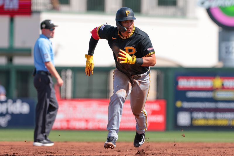 Mar 1, 2026; Jupiter, Florida, USA; Pittsburgh Pirates designated hitter Endy Rodríguez (13) runs toward third base after a wild pitch by St. Louis Cardinals pitcher Ian Bedell (not pictured) during the third inning at Roger Dean Chevrolet Stadium. Mandatory Credit: Sam Navarro-Imagn Images