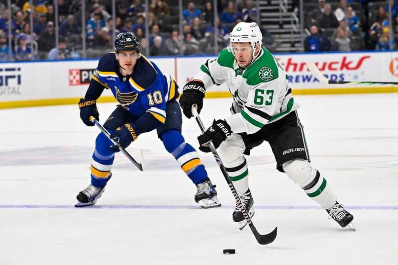 Dec 27, 2023; St. Louis, Missouri, USA;  Dallas Stars right wing Evgenii Dadonov (63) controls the puck against the St. Louis Blues during the third period at Enterprise Center. Mandatory Credit: Jeff Curry-USA TODAY Sports