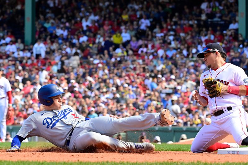 Aug 27, 2023; Boston, Massachusetts, USA; Los Angeles Dodgers first baseman Freddie Freeman (5) slides into third base as Boston Red Sox third baseman Luis Urias (17) mishandles the catch during the fifth inning at Fenway Park. Mandatory Credit: Eric Canha-USA TODAY Sports