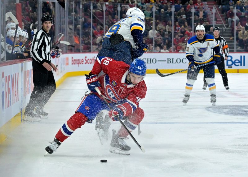 Oct 26, 2024; Montreal, Quebec, CAN; Montreal Canadiens defenseman Lane Hutson (48) takes the puck away from St.Louis Blues forward Pavel Buchnevich (89) during the second period at the Bell Centre. Mandatory Credit: Eric Bolte-Imagn Images