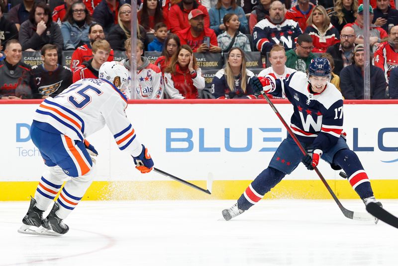 Nov 24, 2023; Washington, District of Columbia, USA; Washington Capitals center Dylan Strome (17) controls the puck in front of Edmonton Oilers defenseman Darnell Nurse (25) in the first period at Capital One Arena. Mandatory Credit: Geoff Burke-USA TODAY Sports