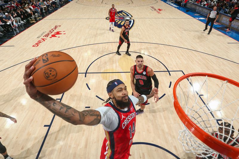 NEW ORLEANS, LA - OCTOBER 23: Brandon Ingram #14 of the New Orleans Pelicans attempts a dunk during the game on October 23, 2024 at the Smoothie King Center in New Orleans, Louisiana. NOTE TO USER: User expressly acknowledges and agrees that, by downloading and or using this Photograph, user is consenting to the terms and conditions of the Getty Images License Agreement. Mandatory Copyright Notice: Copyright 2024 NBAE (Photo by Layne Murdoch Jr./NBAE via Getty Images)